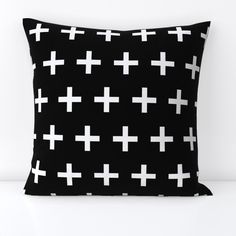 a black pillow with white crosses on it