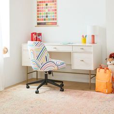 a white desk and chair in a small room