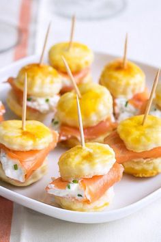 small appetizers are arranged on a plate with toothpicks in the middle