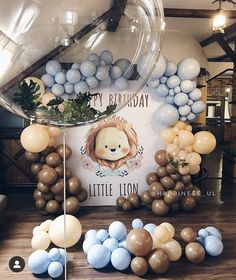 an assortment of balloons and streamers are on the floor in front of a birthday sign