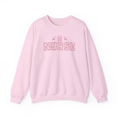 Christmas Nurse Pink Cross Stitch Sweatshirt , a unisex heavy blend crewneck sweatshirt is pure comfort. These garments are made from polyester and cotton. This combination helps designs come out looking fresh and beautiful. The collar is ribbed knit, so it retains its shape even after washing. There are no itchy side seams on these sweaters.  .: Made with a medium-heavy fabric blend of 50% cotton and 50% polyester (8.0 oz/yd² (271.25 g/m this sweatshirt feels cozy and is the perfect choice for those colder months. .: The classic fit along with the crew neckline deliver a comfy wearing experience with a clean-cut style. Meanwhile, the double-needle stitching at the shoulder, armhole, neck, waistband, and cuff seams add top-tier durability.  .: Say goodbye to itchiness thanks to the gray, p Pink Cross Stitch, Stitch Sweatshirt, Nostalgic Aesthetic, Nurse Aesthetic, Professional Nurse, Nurses Week Gifts, Pink Cross, Nurse Sweatshirt, Sweater Gift