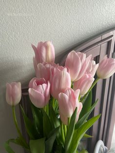 a vase filled with pink flowers sitting on top of a table