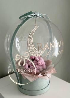 a glass ball with flowers in it sitting on top of a table