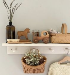 a shelf with wooden toys and baskets on it