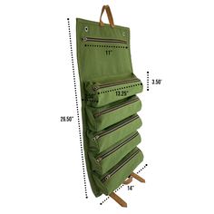 a large green bag hanging on the wall with measurements for it's pockets and zippers