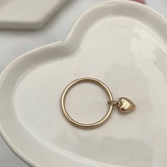 Our Dangling Heart Ring ring is sweetness in a ring, you'll love looking at it all day long while going about your business... wear it in a fun stack or if you're a lover of all things minimalistic you'll rock it alone. Each and every ring is hand-made in our studio at the time of order in sterling silver or 14kt gold fill gold filled wire and features a gorgeous 6mm dangling puffy heart charm. You're going to love creating your custom stack! All of our rings are handmade to order just for you i