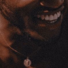 a close up of a person smiling with his mouth open