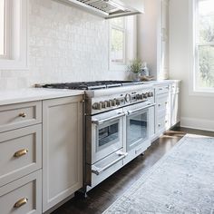 a kitchen with white cabinets and an oven