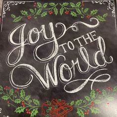 a chalkboard with the words joy to the world written in white and green lettering