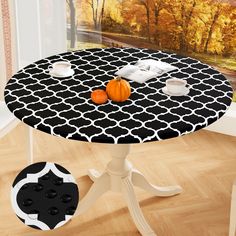 a black and white table with pumpkins on it