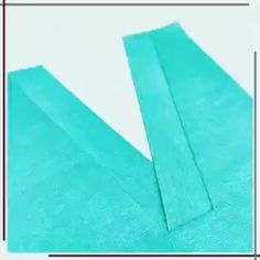 the side view of a piece of blue fabric with a square frame in front of it