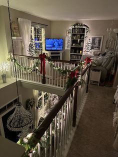 the stairs are decorated with christmas garlands and lights, along with decorations on them