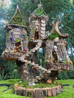 the tree house is made out of logs and has moss growing on it's sides