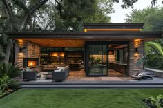 an outdoor living area with couches, tables and fire place in the middle of it