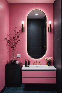 a bathroom with pink walls and black counters