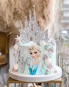 a frozen princess cake is on top of a table in front of other desserts