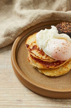 a plate with pancakes and an egg on top