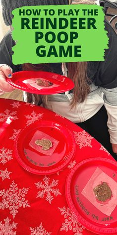 a girl is playing the reindeer poop game on her red table with snowflakes