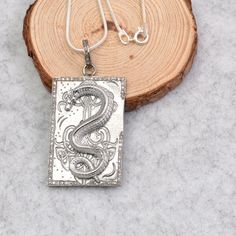 Silver Dragon Pendant Necklace, Chinese Dragon Pendant Charm, Minimalist Dragon Necklace, Necklace For Boyfriend, Diamond Dragon Necklace  Description : This captivating silver necklace features a rectangular pendant adorned with a mesmerizing dragon design. The intricate details of the dragon, from its scales to its claws, are brought to life with expert craftsmanship. The dragon is surrounded by a border of sparkling pavé diamonds, adding a touch of luxury and elegance. The pendant is suspende Diamond Dragon, Necklace For Boyfriend, Boyfriend Necklace, Dragon Necklace, Silver Dragon, Dragon Pendant, Chinese Dragon, Dragon Design, Necklace Necklace