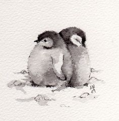 two penguins are sitting next to each other