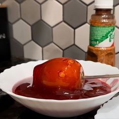 a bowl filled with ketchup on top of a counter