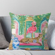 a pink flamingo sitting on top of a leopard pillow