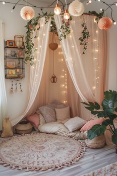 a room with lights and plants on the ceiling, hanging from the ceiling over a bed