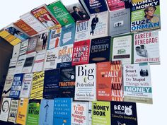 many books are stacked on top of each other in the shape of a wall hanging