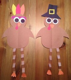 two paper turkeys with hats on their heads