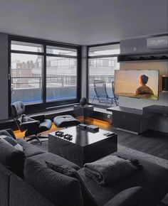 a living room filled with furniture and a flat screen tv mounted to the side of a wall