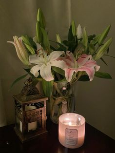 a candle and some flowers on a table