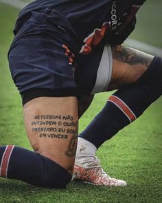 a soccer player with tattoos on his leg