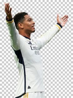 a soccer player with his arms in the air, holding his hands up and looking at something