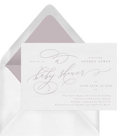 an open envelope with the word baby shower written in cursive writing on it