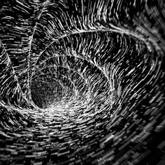 an abstract black and white photo with lines in the center that appear to have been distorted