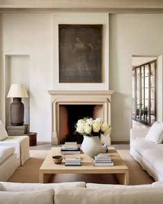 a living room filled with furniture and a fire place in front of a painting on the wall