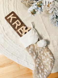 a wooden sign that says krav next to a christmas tree with decorations on it