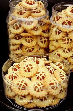 several plastic containers filled with cookies on top of a table