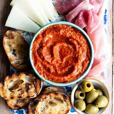 an assortment of food including bread, olives and cheese