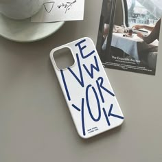 a phone case sitting on top of a table next to a cup and saucer