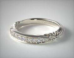 a white gold wedding ring with diamonds on the sides and an arrow design in the middle