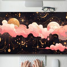 a person typing on a computer keyboard in front of a wall with clouds and stars