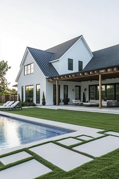 a large white house with a pool in the yard