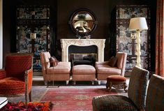 a living room filled with furniture and a fire place in front of a wall mounted mirror