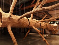 a large wooden insect sculpture hanging from the ceiling