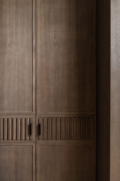 a wooden closet with two doors and drawers