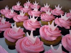 cupcakes with pink frosting and white crowns on top