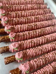 there are many pink desserts arranged in rows on the tray, ready to be eaten