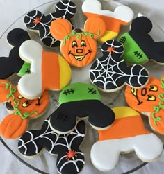 decorated cookies in the shape of mickey mouses and jack - o'- lanterns