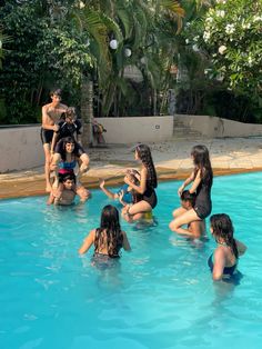 a group of people sitting around in a swimming pool